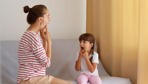 Mother kneeling to talk calmly with her child