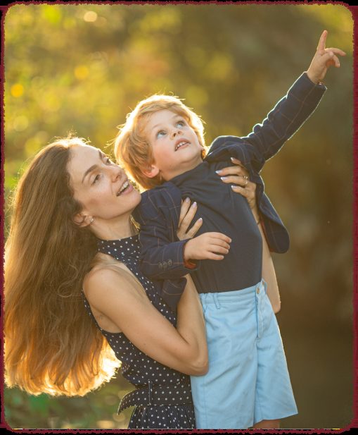 Mother and child laughing together outdoors